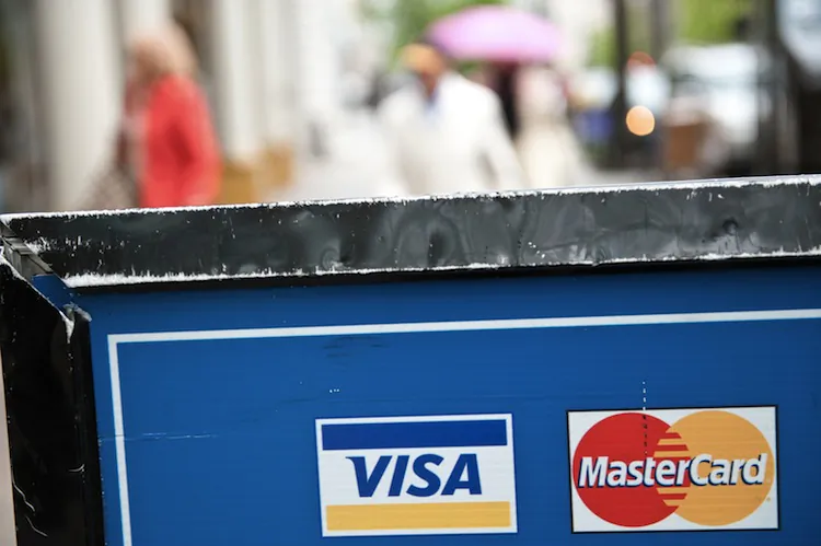 Visa and MasterCard credit card logos on a sign in Washington on March 30, 2012. (Nicholas Kamm/AFP/Getty Images)