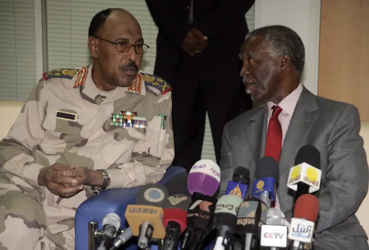 Sudanese Defense Minister Abdel Rahim Mohamed Hussein (L) and chief African Union mediator and former South African president Thabo Mbeki (R) speak prior to their press conference about the release of the UN deminers on May 20, 2012. (Ashraf Shazly/AFP/GettyImages)