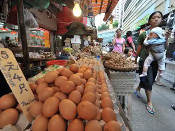 A vendor sells eggs from Thailand at a market stall in Hong Kong. Chinese eggs are now suspect after melamine-contaminated eggs turned up in Hong Kong.    (Mike Clarke/AFP/Getty Images)
