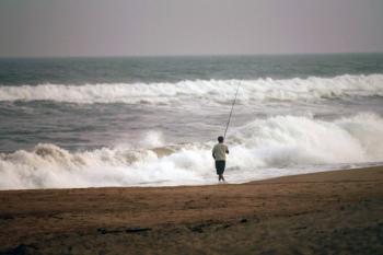 OMINOUS: A man fishes in rough surf on Friday in Montauk, New York. Much of the East Coast is preparing for Hurricane Earl. (Spencer Platt/Getty Images)