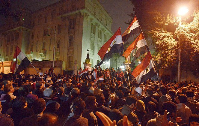 Egyptian protesters gather outside of the presidential palace in Cairo on Dec. 4. While American media coverage of Arab Spring protests was thorough, Egyptian activists say the truth of widespread protest and violence under President Morsi is barely acknowledged. (Gianluigi Guercia/AFP/Getty Images)