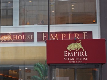 The steakhouse's glass, modern exterior is a stark contrast to the warmth that waits inside. (Courtesy of Empire Steakhouse)