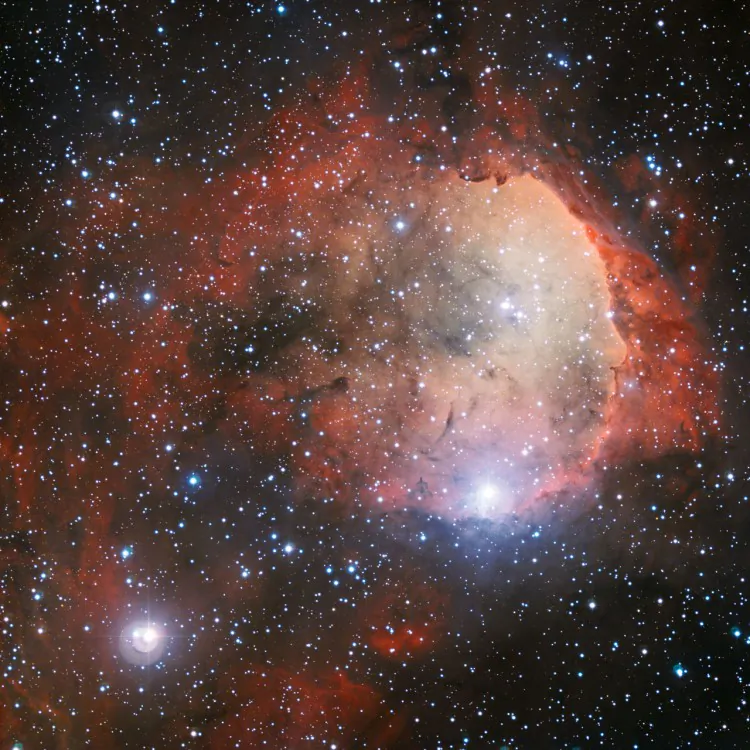 The intense radiation from several of NGC 3324's massive, blue-white stars has carved out a cavity in the surrounding gas and dust. The ultraviolet radiation from these young hot stars also cause the gas cloud to glow in rich colors. (European Southern Observatory)