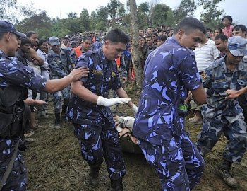 Nepalese police recover the body of a passenger who died when a Buddha Air Beechcraft 1900D aircraft crashed at Kot Danda in Lalitpur, on the outskirts of Kathmandu, on September 25. (Prakesh Mathema/AFP/Getty Images)