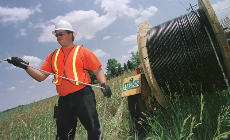 A reeltender installs fiber optic cable in regional America. Bruce Abrahams from North Georgia Network said he and his colleagues did not know "fiber from muffins" when they first discussed rolling out a fast speed broadband network in north Georgia. (Michael Smith/Getty Images)