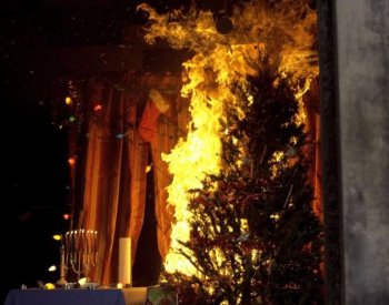 As a demonstration encouraging fire safety, a holiday display is set on fire by the Fire Department of New York on Monday. (Phoebe Zheng/The Epoch Times)