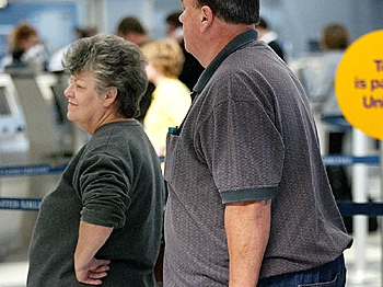 A heavy-set couple check in for a flight. (Tim Boyle/Getty Images)