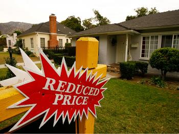 A 'Reduced Price' sign sits in front of a house in Glendale, California. (David McNew/Getty Images)