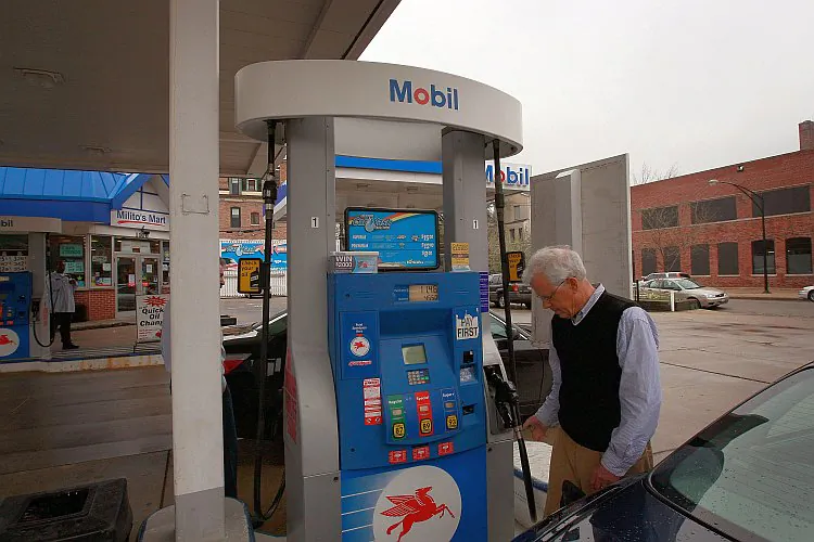 A motorist fuels his car at a Mobil station in Chicago in this file photo from 2009. ExxonMobil has divested its Japanese business to its local partner on Sunday for $3.9 billion. (Scott Olson/Getty Images)