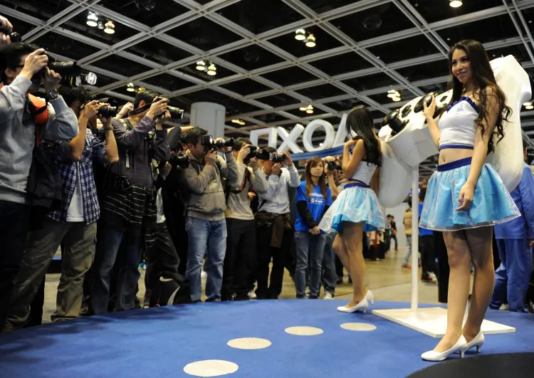 Photographers line up to take pictures of Sony Playstation promotion staff during the Asia Game Show (AGS) in Hong Kong on Dec. 22, 2012. A restriction on the ban of consoles in China was considered recently, according to reports in the state-run press. (Dale de la Rey/AFP/Getty Images)