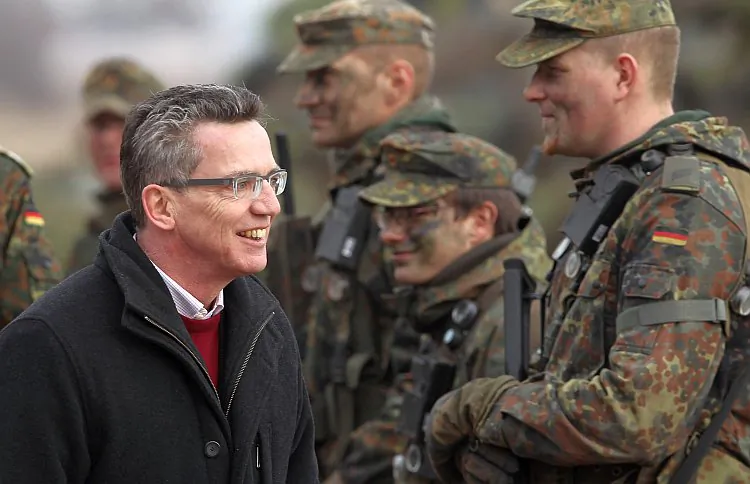 German Defense Minister Thomas de Maizière greets troops of the 37th Armored Infantry Brigade at the Bundeswehr combat training center on March 9, 2011, in Letzlingen, Germany. (Sean Gallup/Getty Images)