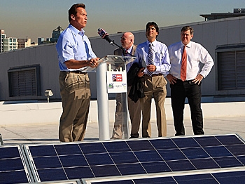California Gov. Arnold Schwarzenegger speaks at a news conference for the installation the last of 1,727 solar panels on the rooftop of the Staples Center sports complex in Los Angeles, California. Despite such promotions, the green energy industry in Ame (David McNew/Getty Images)