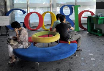 Visitors sit on a bench at a lobby of an office of Google Korea in Seoul on August 11. South Korean police searched the offices of Google Korea to investigate whether it breached privacy law in collecting information for its Street View service. (Park Ji Hwan/Getty Iamges )