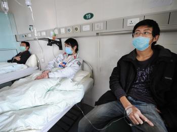 Chinese swine flu patients undergo treatment at a hospital in Hefei in eastern China's Anhui province on Nov 25. The number of infected patients is so high in China that some doctors are telling patients to stay home in quarantine. (STR/AFP/Getty Images)