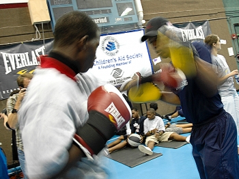 U.S. Olympic boxing coach Robert Martin (right) trains Zakurl Burrell (left), a camper from the Boys and Girls Club, giving him individual, hands-on attention. (Ally Wang/The Epoch Times) U.S. Olympic boxing coach Robert Martin (right) trains Zakurl Burrell (left), a camper from the Boys and Girls Club, giving him individual, hands-on attention. (Ally Wang/The Epoch Times)