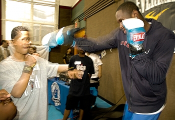 Olympic boxer Deontay Wilder (right) a camper from the Boys and Girls Club one-on-one, hand-to-hand training. (Ally Wang/The Epoch Times) Olympic boxer Deontay Wilder (right) a camper from the Boys and Girls Club one-on-one, hand-to-hand training. (Ally Wang/The Epoch Times)