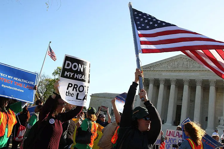 People march in favor of the Patient Protection and Affordable Care Act in front of the U.S. Supreme Court on March 26, 2012 in Washington, DC. Today the high court, which has set aside six hours over three days, will hear arguments over the constitutionality President Barack Obama's Patient Protection and Affordable Care Act. (Mark Wilson/Getty Images)