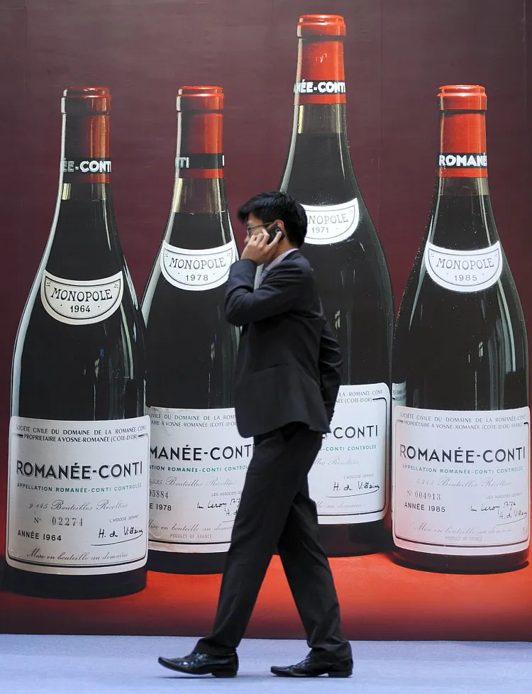 A man walks past a poster advertising fine wines at a Sotheby's auction preview in Hong Kong, March 2011. Hong Kong in the past few years has been the world’s pre-eminent wine market, with several recent record-breaking wine auctions, but wine prices have now fallen for three consecutive quarters. (Mike Clarke/AFP/Getty Images)