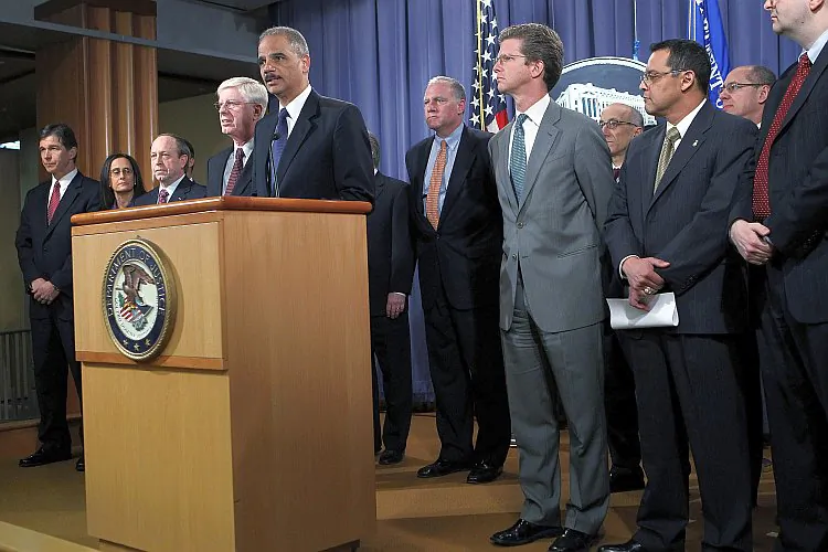 U.S. Attorney General Eric Holder (5th L) speaks during a news conference on Feb. 9 at the Department of Justice in Washington, while Housing and Urban Development Secretary Shaun Donovan (5th R), Colorado Attorney General John Suthers (3rd L), Iowa Attorney General Tom Miller (4th L), and other officials listen on. Holder announced that the federal government and 49 state attorneys general have reached a $25 billion agreement with the nation's five largest mortgage lenders to address mortgage loan serving and foreclosure abuses. (Alex Wong/Getty Images)