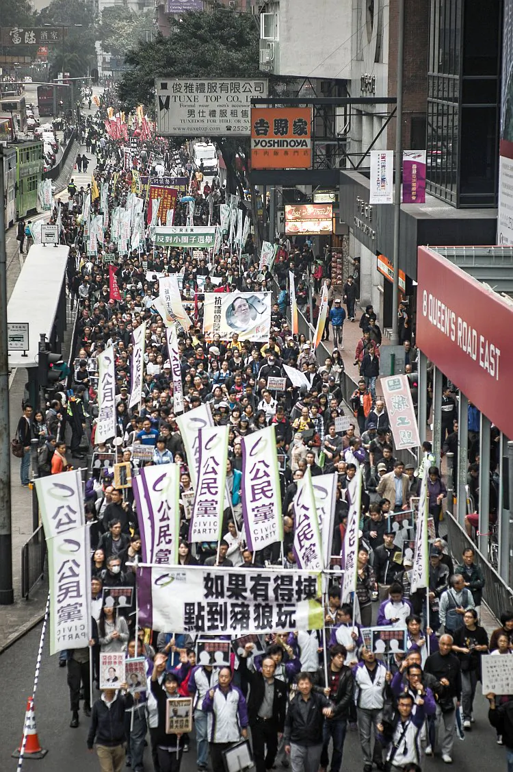 Protesters march to voice their dissatisfaction with the territory's leader, Chief Executive Donald Tsang, in Hong Kong on March 3, 2012. They also called for direct elections in the southern Chinese territory ahead of elections on March 25. Tsang, whose term is up in June, agreed on March 1 to cooperate with an investigation into his alleged ties to rich tycoons, after revelations of his jaunts on private jets and yachts, and denied he had breached bribery laws. (Philippe Lopez/AFP/Getty Images)