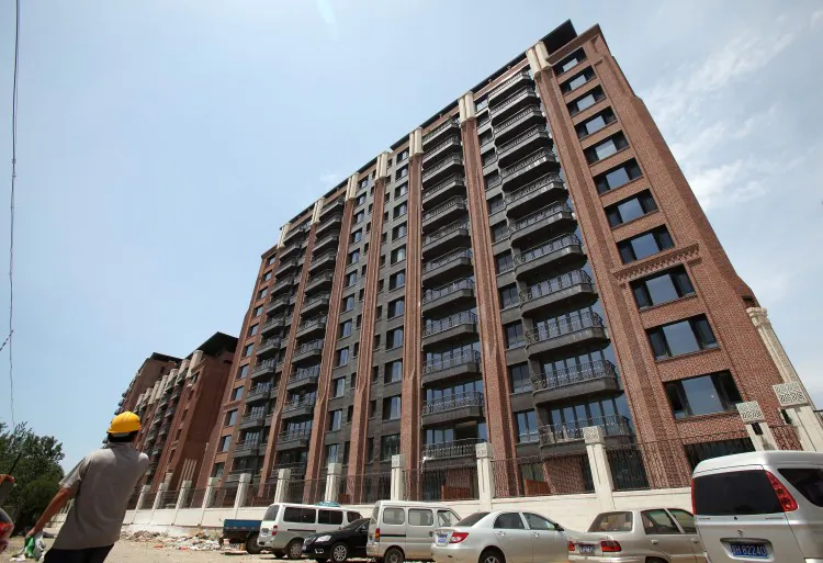 Prices for new homes in Beijing and other cities in China have been skyrocketing. Apartments in buildings like this one, photographed in June 2011, sold for 300,000 yuan (46,000 USD) per square meter. (STR/AFP/Getty Images)