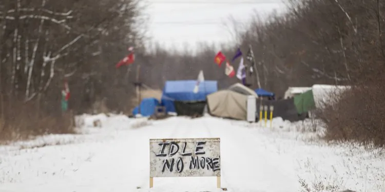 First Nations protesters continue to blockade the CN tracks in Sarnia, Ont., on Wednesday, January 2, 2013, after a court injunction to have them move was issued over the holidays. The protest, part of the Idle No More movement, has blocked the tracks for 13 days. (The Canadian Press/ Geoff Robins)