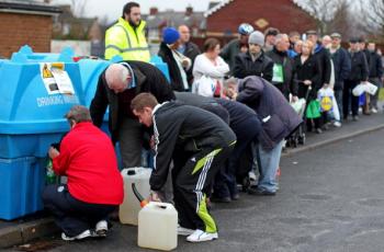 People queue to fill bottles and tanks with water at the Avoniel Leisure Centre in Belfast, Northern Ireland on December 29, 2010. (Peter Muhly/AFP/Getty Images)