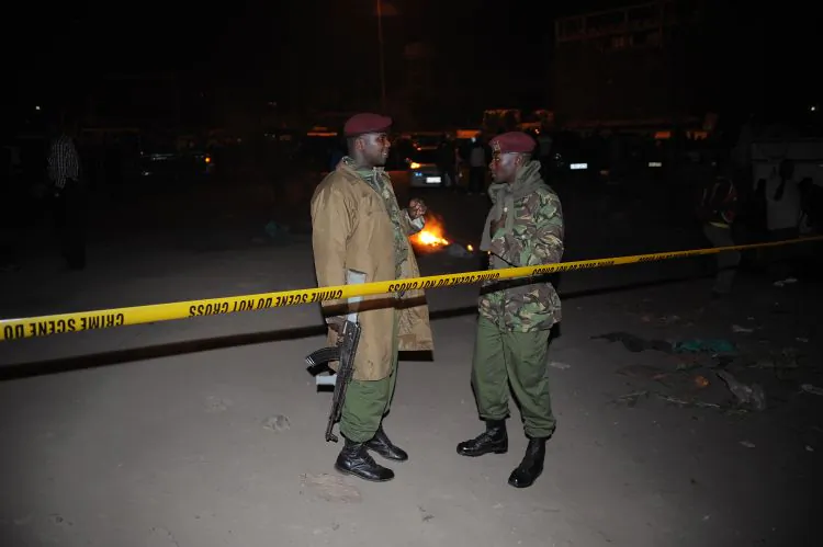 Kenyan policemen secure the blast area after explosions at a bus station in downtown Nairobi killed at least three people on March 10. (Simon Maina/AFP/Getty Images)
