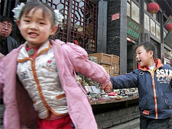 Children hold hands while walking along a street in the ancient city of Pingyao, in northern China's Shanxi province. China's skewed sex ratio has been one consequence of its one-child policy, as many couples, particularly in rural areas, prefer a boy and (Frederic J. Brown/AFP/Getty Images) Children hold hands while walking along a street in the ancient city of Pingyao, in northern China's Shanxi province. China's skewed sex ratio has been one consequence of its one-child policy, as many couples, particularly in rural areas, prefer a boy and (Frederic J. Brown/AFP/Getty Images)