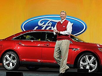 Ford President and CEO Alan Mulally arrives on stage beside a new Ford Taurus to deliver the opening keynote address at the 2010 International Consumer Electronics Show, January 7, 2010 in Las Vegas, Nevada. (Robyn Beck/AFP/Getty Images)