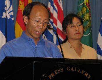Former Falun Gong prisoner of conscience He Lizhi speaking at a press conference on Parliament Hill in Ottawa on August 1. Mr. He was imprisoned for 3 1/2 years in China. To the right is Lucy Zhou, spokesperson for the Falun Dafa Association of Canada. (Donna He/The Epoch Times)