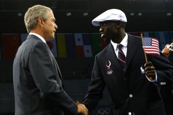 US President George W. Bush greets Lopez Lomong, runner and flagbearer for the United States of America Olympic team, on the opening day of the Beijing 2008 Olympic Games. (Jamie Squire/Getty Images)