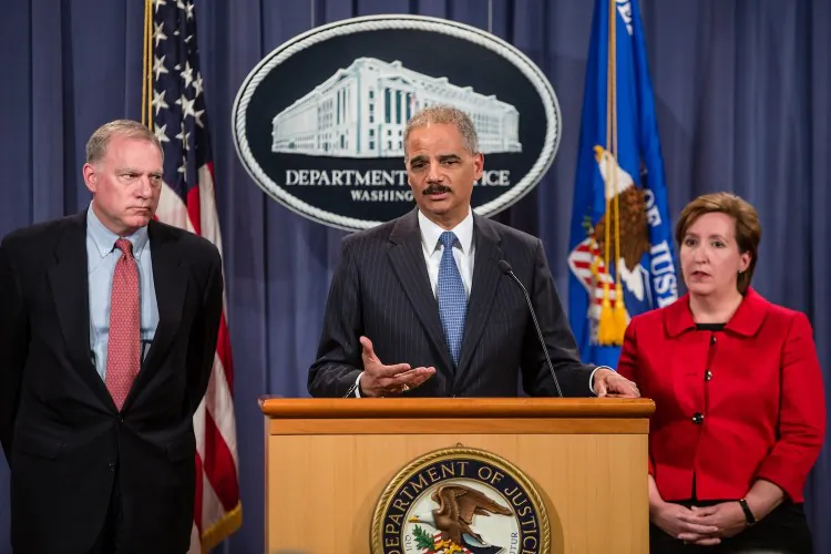 Connecticut Attorney General George Jepsen, U.S. Attorney General Eric Holder, and Acting Assistant Attorney General of the Anti-trust Division Sharis A Pozen announce an anti-trust lawsuit filed against Apple at the U.S. Department of Justice on April 11 in Washington, D.C. A class action suit was filed by a Canadian lawyer in the BC Supreme Court last week. Apple is accused of setting the price of e-books artificially high. (Brendan Hoffman/Getty Images)