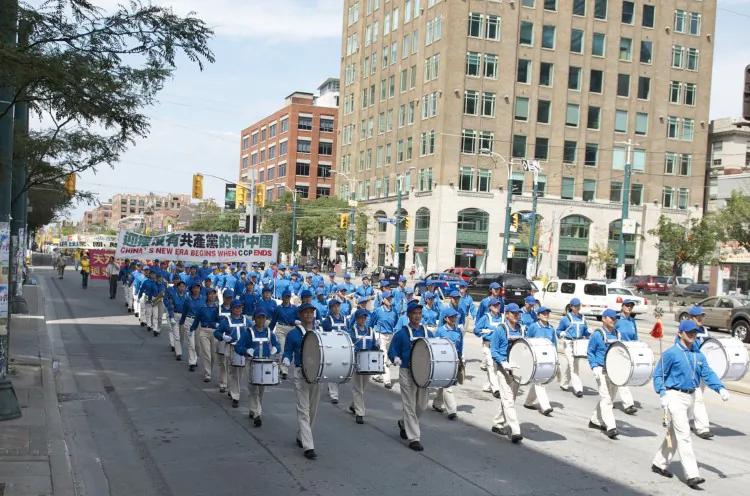 A parade moves through Chinatown in Toronto on Aug. 13 to support 100 million Chinese people who have withdrawn from the Chinese Communist Party.  (Matthew Little/The Epoch Times)