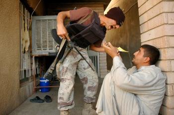 'MAD MONEY MIKE':Ashley Gilbertson captured a violent interrogation being held by an Iraqi lieutenant, 'Mad Money Mike,' who was trained by the U.S. Army and commissioned to conduct interrogations. The interrogator eventually stabbed his interviewee.(Photo by Ashley Gilbertson) 'MAD MONEY MIKE':Ashley Gilbertson captured a violent interrogation being held by an Iraqi lieutenant, 'Mad Money Mike,' who was trained by the U.S. Army and commissioned to conduct interrogations. The interrogator eventually stabbed his interviewee.(Photo by Ashley Gilbertson)