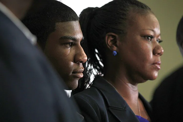 Family of Trayvon Martin, mother Sybrina Fulton (R) and brother Jahvaris Fulton (L), listen on April 11 to a statement about Florida special prosecutor Angela Corey's announcement that George Zimmerman was charged with second degree murder in the death of Trayvon Martin. (Alex Wong/Getty Images)