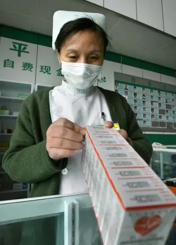 A hospital worker at a dispensary stocks up on medicine for general health in Beijing. Chinese counterfeit medicines have likely caused hundreds if not thousands of deaths outside of China in recent years. (Frederic J. Brown/AFP/Getty Images)