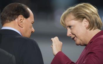 German Chancellor Angela Merkel (R) speaks with Italian Prime Minister Silvio Berlusconi (L) during the morning G20 plenary session at the Pittsburgh Convention Center in Pittsburgh on September 25, 2009. (Jim Watson/AFP/Getty Images)