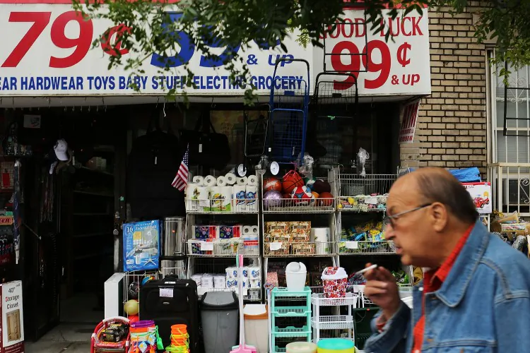 A man walks by a discount store on June 12 in the Brooklyn borough of New York City. The U.S. middle class shrank by 10 percent between 1971 and 2011, according to a recent study. (Spencer Platt/Getty Images)