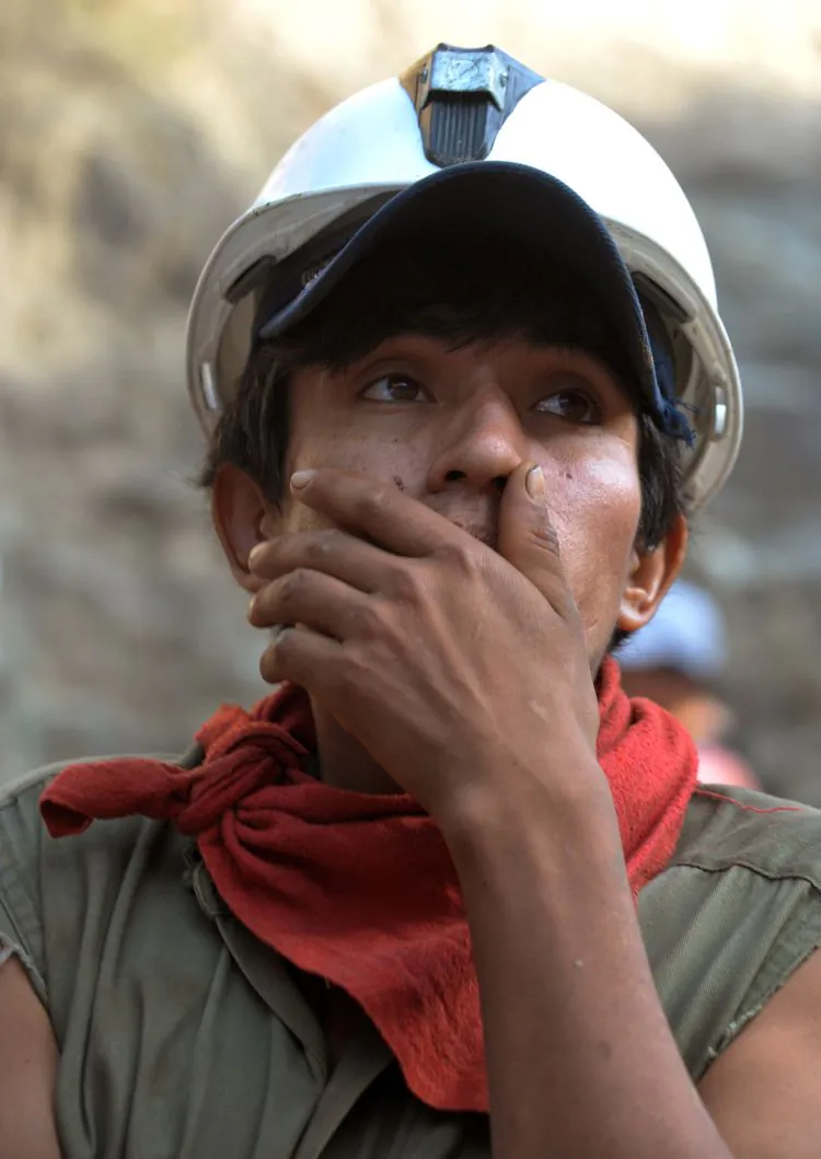 A young miner waits for his shift to participate in the rescue operation of nine colleagues who have been trapped underground following the collapse of a shaft in the Cabeza de Negro copper mine in in the Andes east of Ica, south of Lima, on April 8 (Cris Bouroncle/AFP/Getty Images)