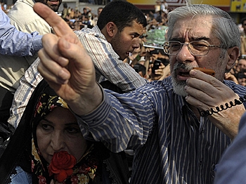 Defeated Iranian presidential candidate Mir Hossein Mousavi addresses supporters as he attends a rally with his wife Zahra Rahnavard in Tehran on June 15, 2009. (Olivier Laban-Mattei/AFP/Getty Images) Defeated Iranian presidential candidate Mir Hossein Mousavi addresses supporters as he attends a rally with his wife Zahra Rahnavard in Tehran on June 15, 2009. (Olivier Laban-Mattei/AFP/Getty Images)