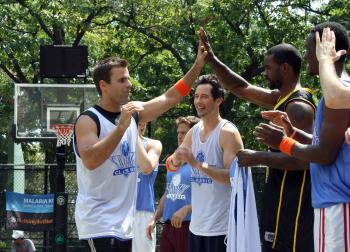 A celebrity line up and high five hype up before the first annual 'Nothing But Net' charity basketball game, organized by Tom Cavanagh (3rd from right) and 'Dancing With the Stars' star, Cameron Matheson (left). (Katy Mantyk The Epoch Times)