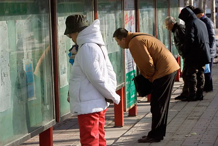 File photo of people reading the daily newspapers posted on public bulletin boards Beijing. (Teh Eng Koon/AFP/Getty Images)