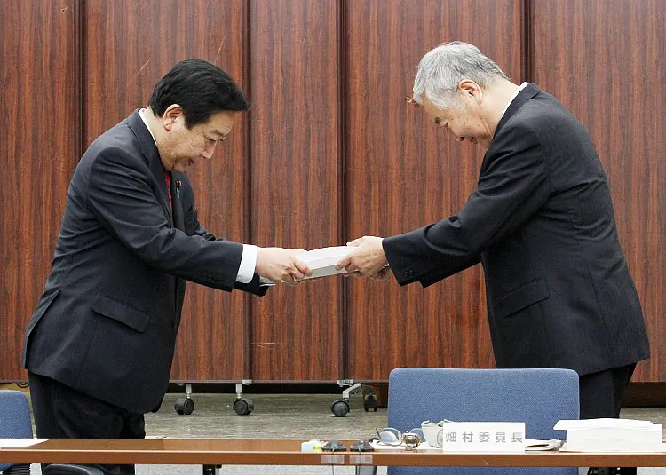 Japanese Prime Minister Yoshihiko Noda (L) receives the final report from Yotaro Hatamura (R), chairman of the government-appointed investigation and verification committee for the accident at TEPCO's Fukushima nuclear power station, in Tokyo on July 23. ( Jiji Press/AFP/GettyImages)
