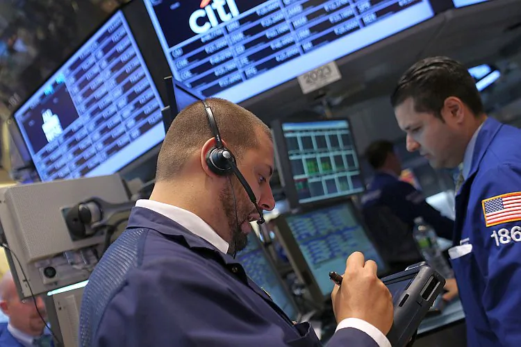 Traders work on the floor of the New York Stock Exchange on June 18, in New York City. U.S. stocks rose Tuesday, propelled on speculation that the Federal Reserve may be pondering new action to jumpstart the sluggish economy. (Spencer Platt/Getty Images)