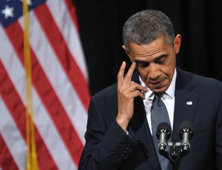 People mourn as they listen to President Barack Obama give a speech at an interfaith vigil for the shooting victims from Sandy Hook Elementary School on Dec. 16, 2012, at Newtown High School in Newtown, Conn. (Stephen Dunn-Pool/Getty Images)