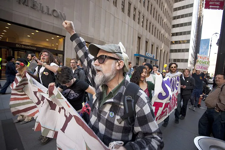 Demonstrators associated with the Occupy Wall Street movement march up Broadway near Wall Street on April 6, in New York City. (Michael Nagle/Getty Images)