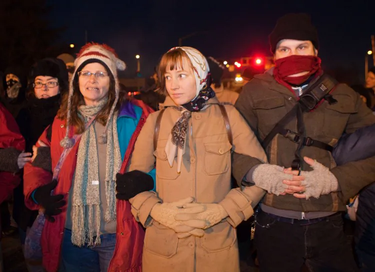 Protesters participating in the 'Occupy the Ports' event link arms as the block the entrance of Port #6 December 12, 2011 in Portland, Oregon. Hundreds Occupy Portland protesters effectively shut down two of the Port of Portland's busiest terminals, preventing about 200 longshore workers from going to work. (Natalie Behring/Getty Images)