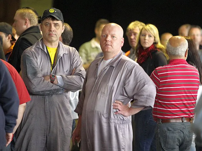 Employees of the car company Opel gather after a meeting at the Opel plant in Bochum, Germany, May 21. Opel is planning to cut working hours of its German workforce in half starting in September. (Roland Weihrauch/AFP/GettyImages)