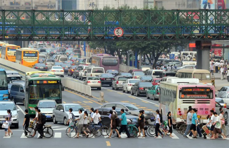 Pedestrians cross the road past heavily congested traffic in the town center in Guangzhou in the southern Chinese province of Guangdong on Sept. 27, 2010. (Mike Clarke/AFP/Getty Images)